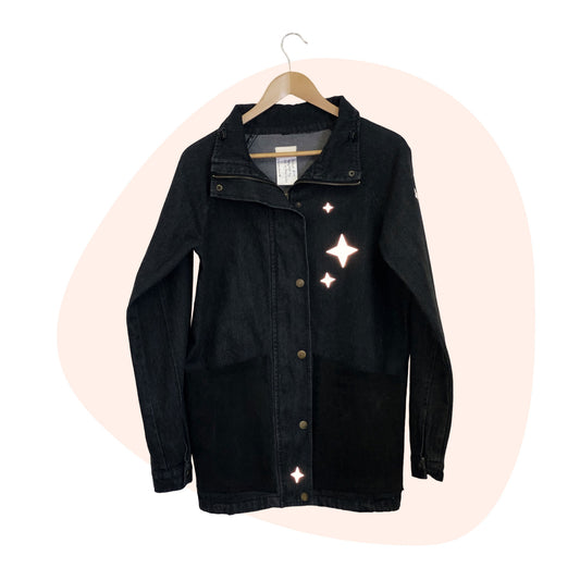A black denim jacket with stars on it.
