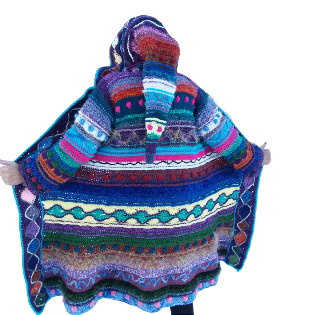 A woman wearing a colorful crochet hooded coat.