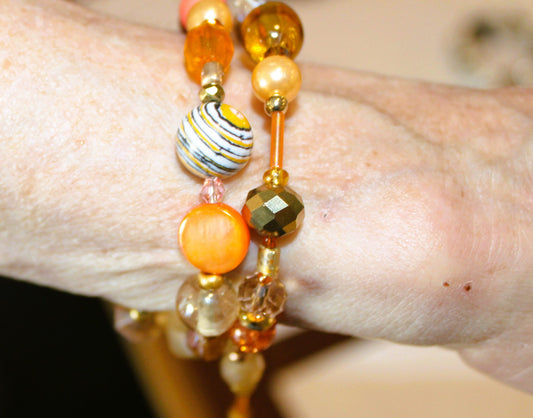 A woman's hand with a bracelet on it.