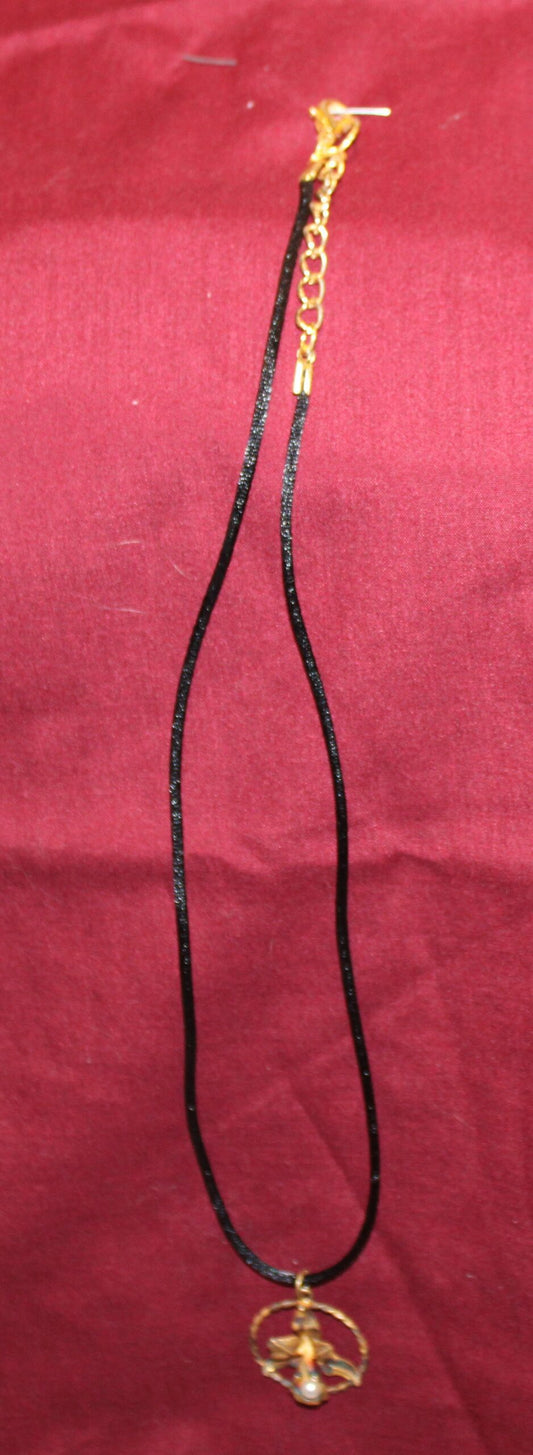 An antique orchid gold-tone pendant with a new silk cord necklace.
