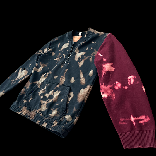 A black and red sweater with blotches on it.