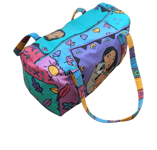 A colorful duffel bag with cartoon characters on it.