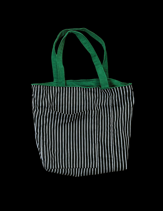 A black and white striped tote bag on a black background.