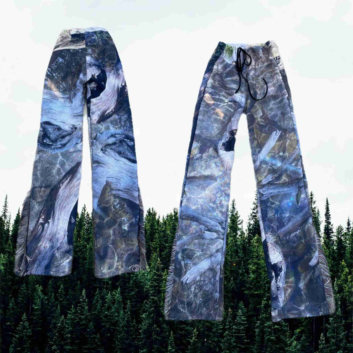 a pair of skis with trees in the background.