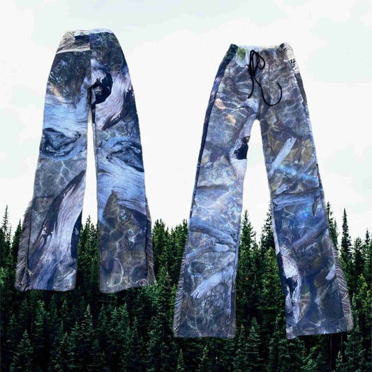 a pair of skis with trees in the background.