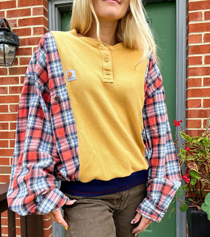 A blonde woman wearing a yellow and blue plaid shirt.