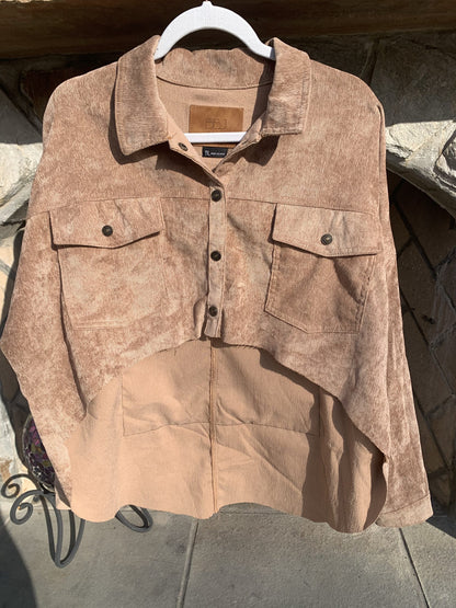 A Nirvana Corduroy Jacket hanging on a clothes rack.