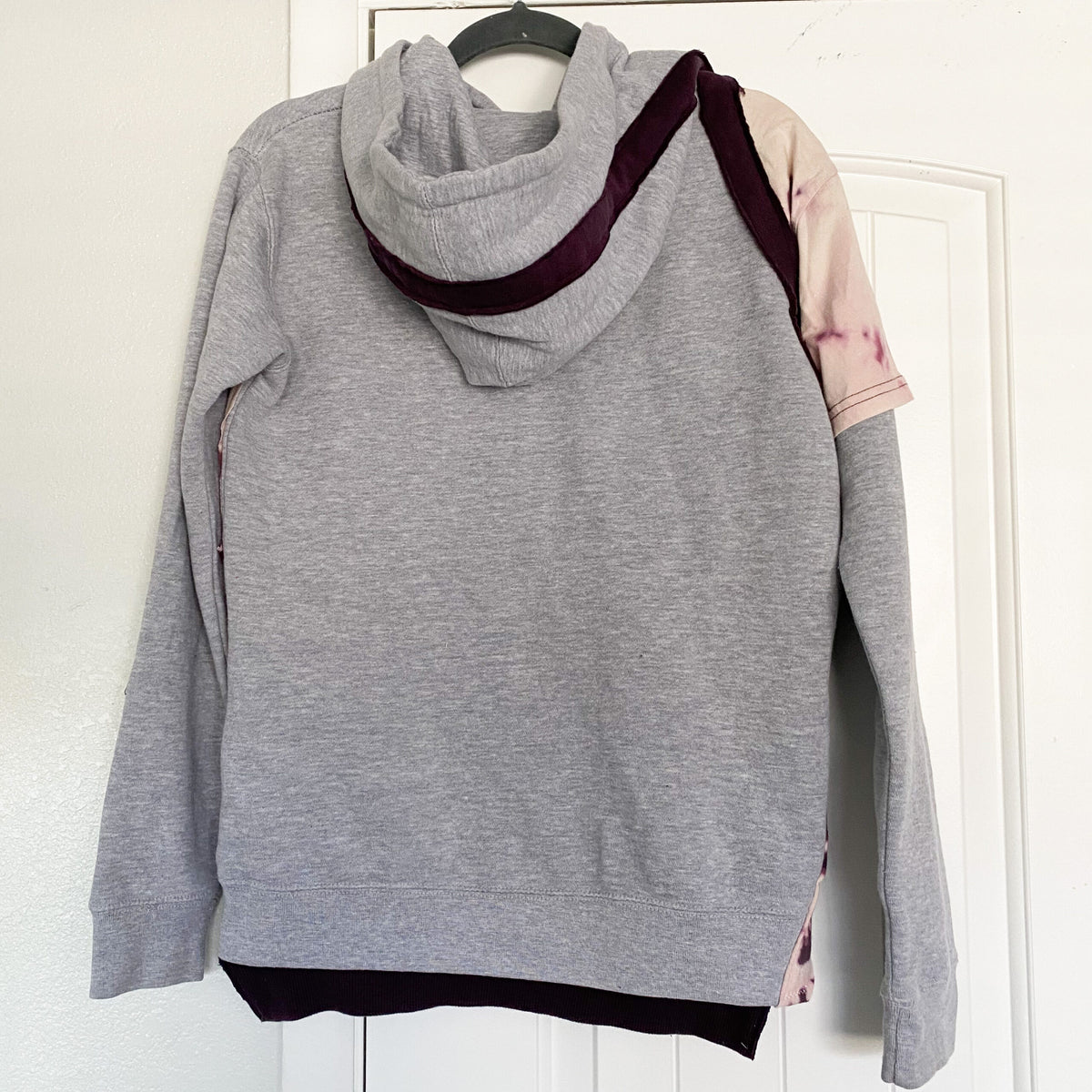 A grey sweatshirt on a door.