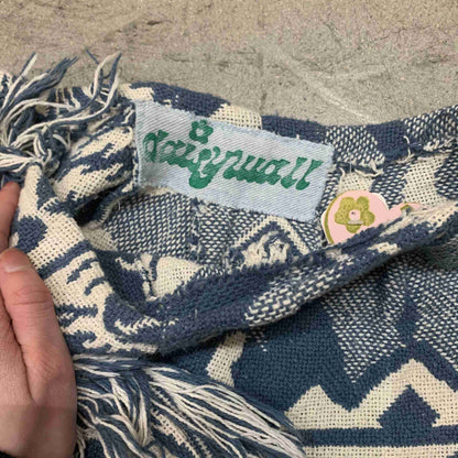 a person holding a scarf with a tag on it.