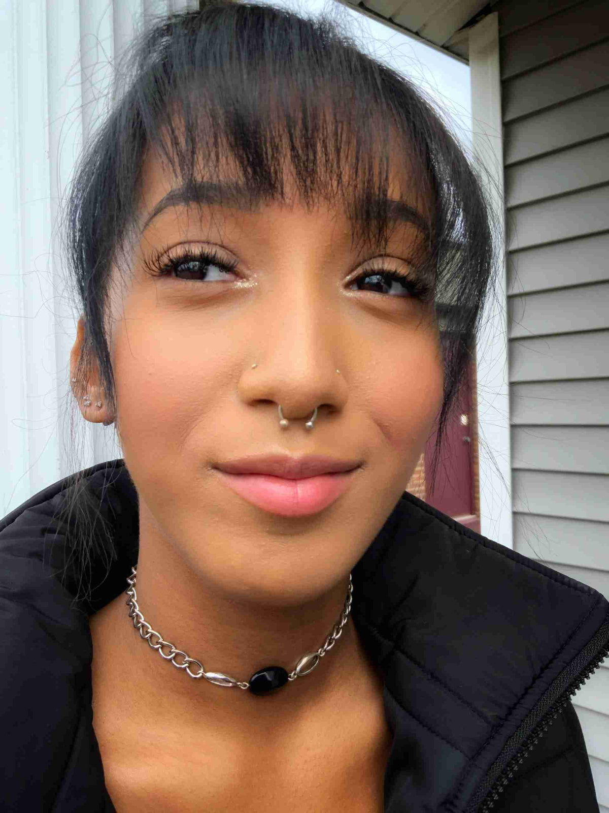 a close up of a person wearing a necklace.