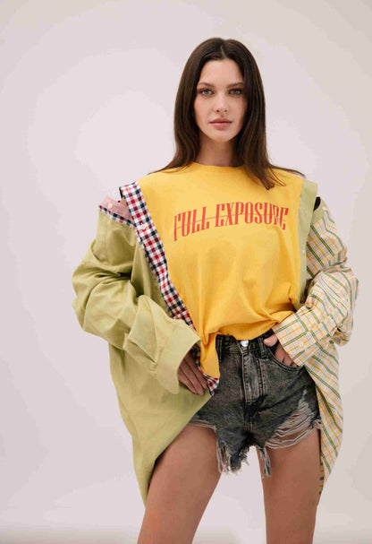 a woman wearing a yellow shirt and shorts.