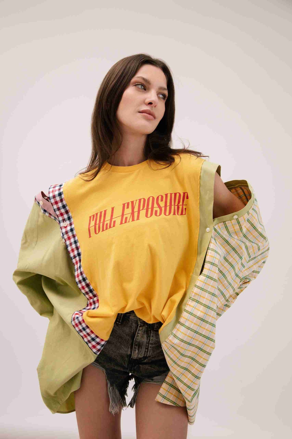 a woman in a yellow shirt and shorts.