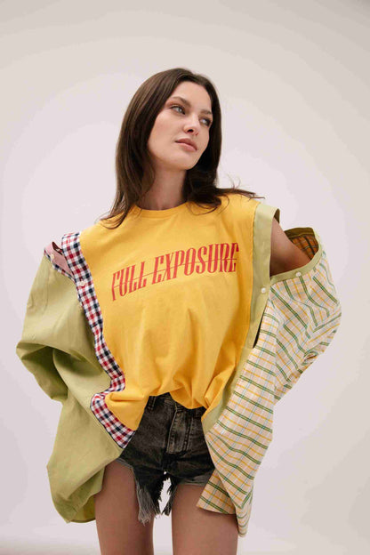 a woman in a yellow shirt and shorts.