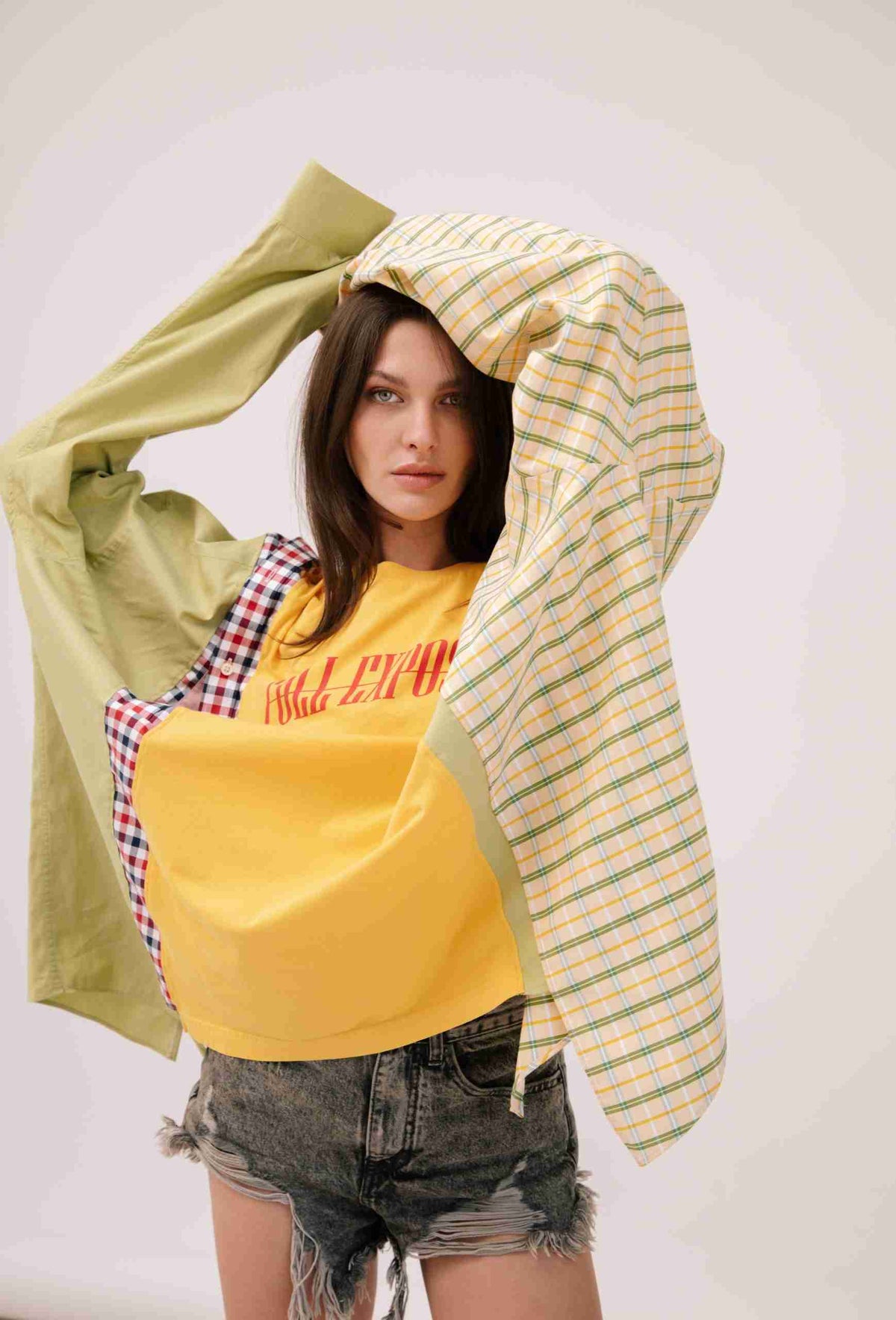 a woman with a yellow shirt and plaid shirt.
