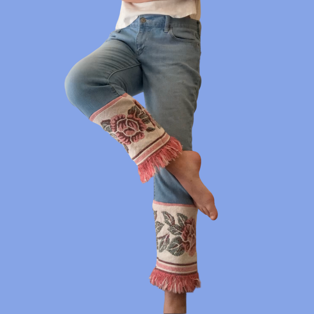 A woman wearing a pair of jeans with fringes.