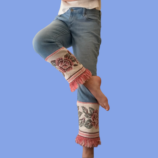 A woman wearing a pair of jeans with fringes.