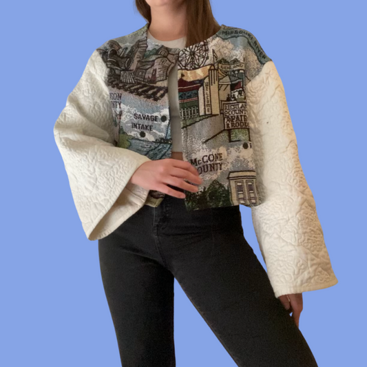A woman wearing a quilted jacket and jeans.