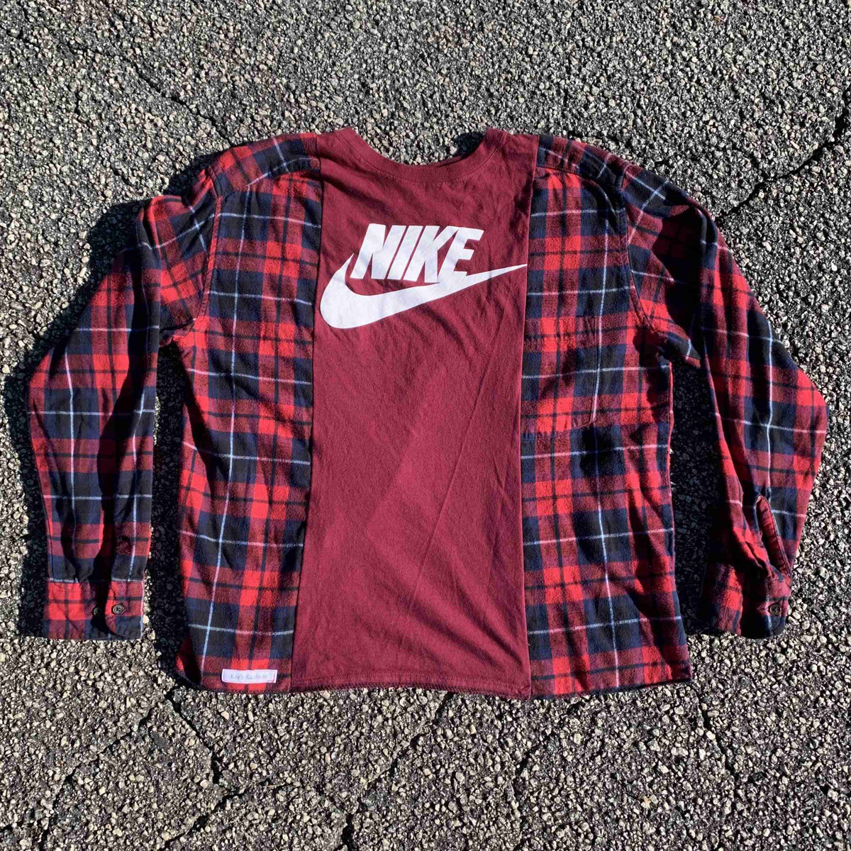 a red and black shirt with a white nike logo on it.