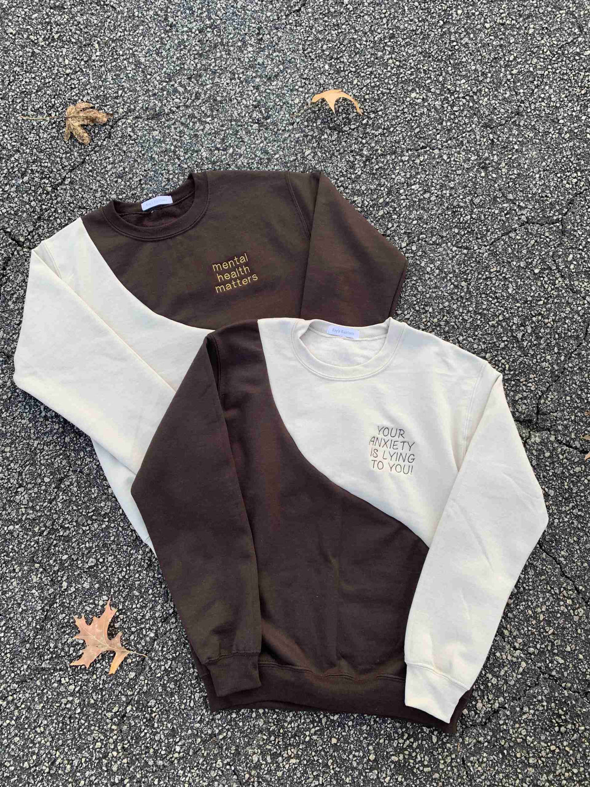 a couple of sweaters laying on the ground.