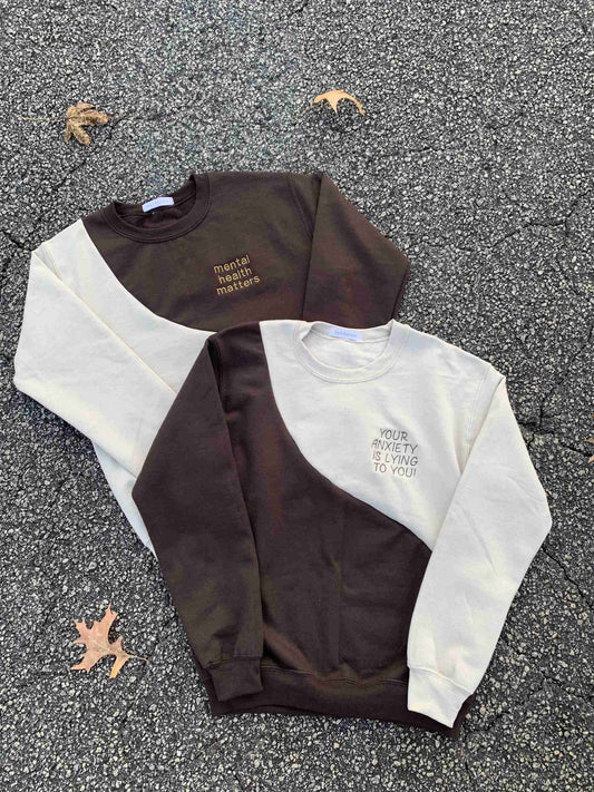 a couple of sweaters laying on the ground.