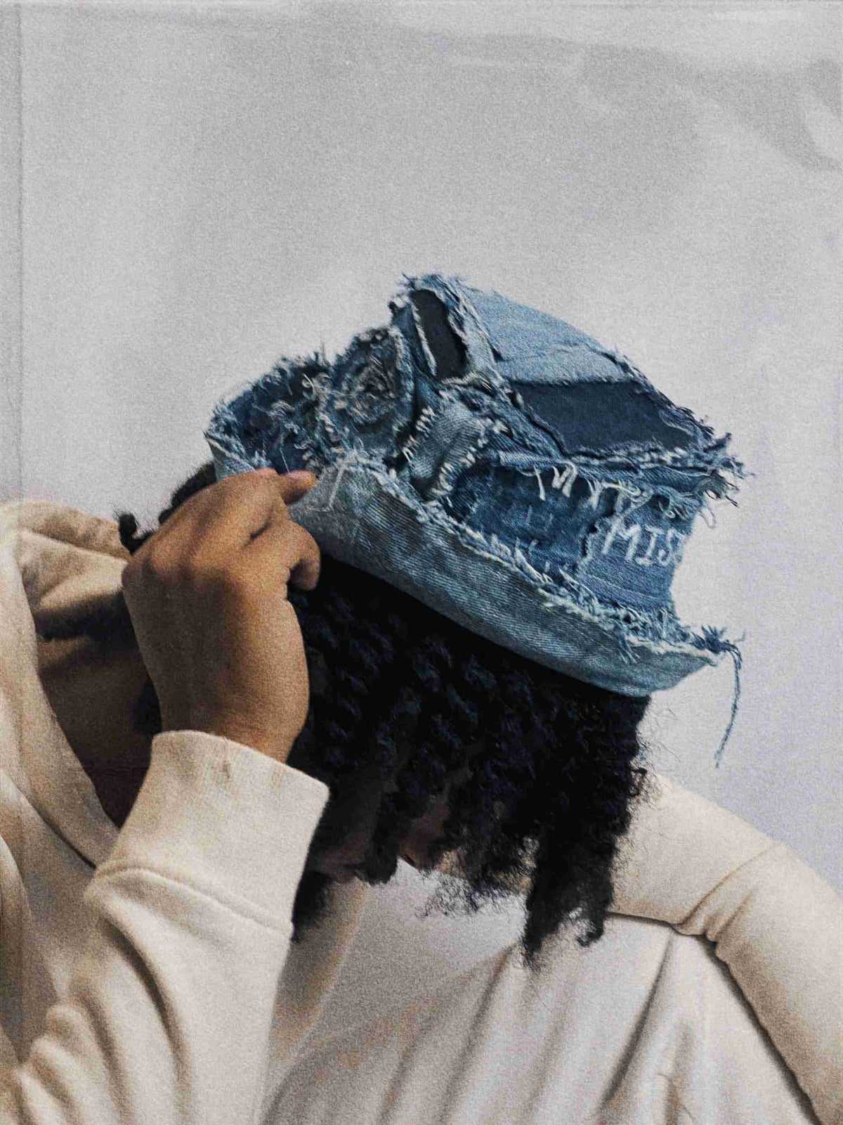 a person with a hat that has a hole in it.