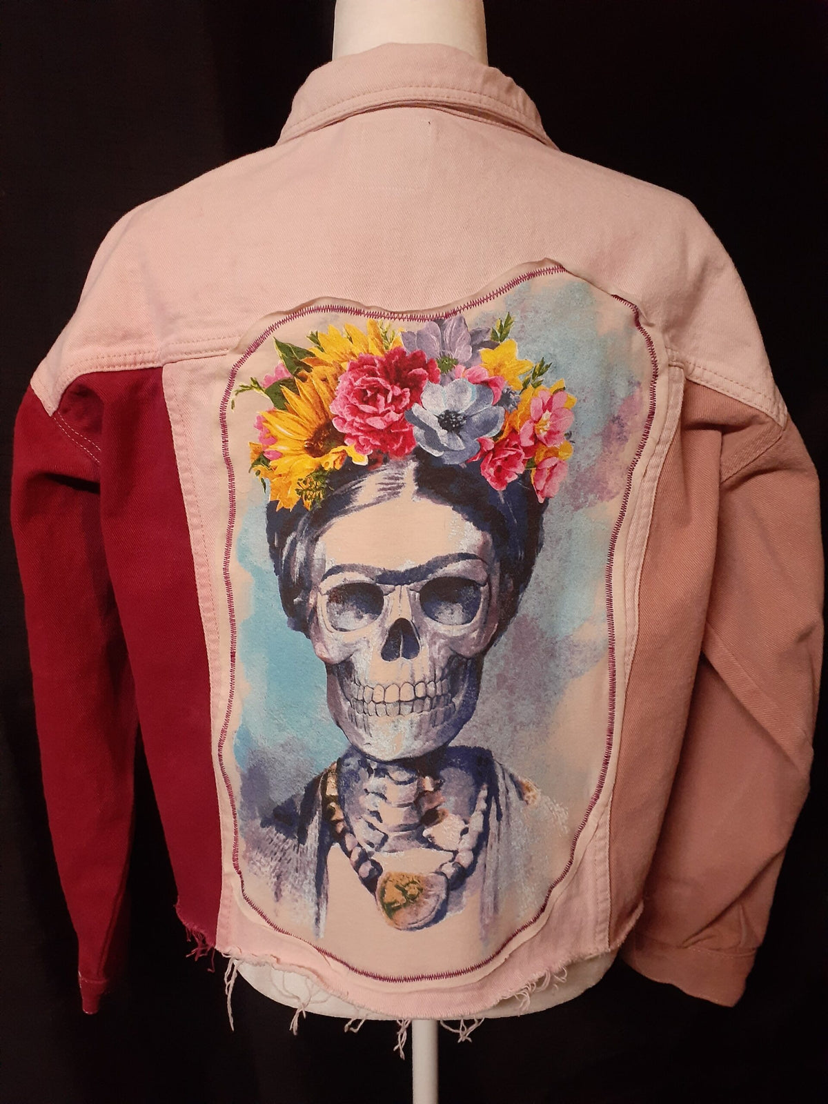 Skull & Flowers Frida Kahlo inspired pink color block denim jacket Large with a picture of a skeleton wearing a flower crown.