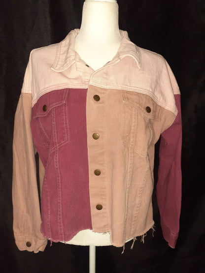A white mannequin with a Skull & Flowers Frida Kahlo inspired pink color block denim jacket Large on top of it.