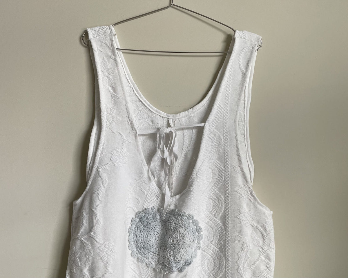 a white top hanging on a wall.