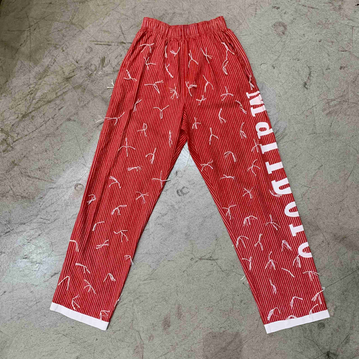 a pair of red pants with white writing on them.