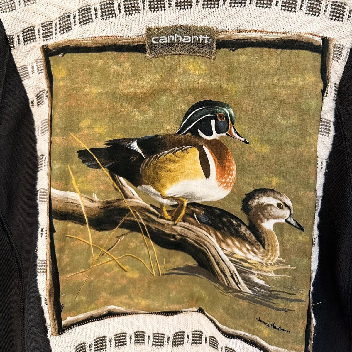 a picture of Neutral Duck & Carhartt Grandpa Sweater Rework sitting on a branch.