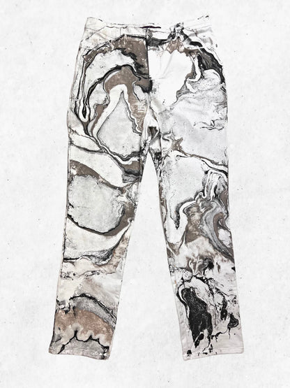 A pair of marbled pants on a white surface.