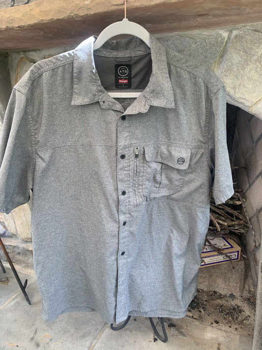 An AC/DC Let There Be Rock gray button up shirt hanging on a clothes rack.