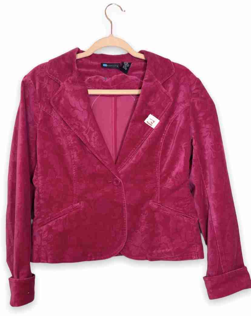 a pink jacket hanging on a hanger.