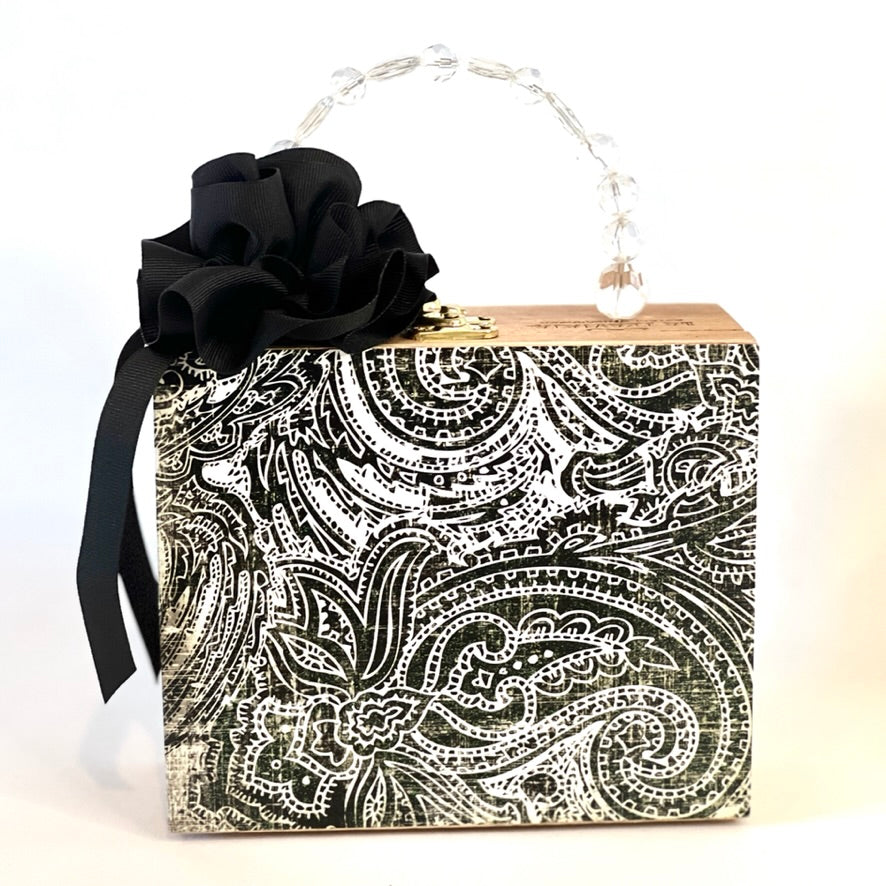Square box purse with black & white paisley print and ribbon rose embellishment.