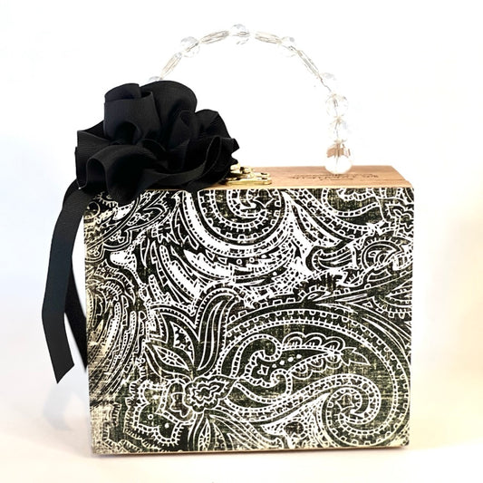 Square box purse with black & white paisley print and ribbon rose embellishment.