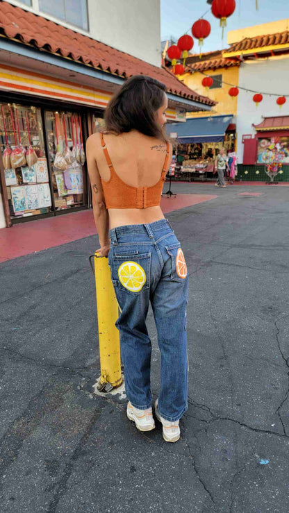 a woman standing on the street with her back to the camera.
