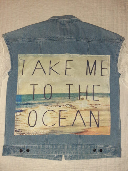 Take Me To The Ocean upcycled denim & lace jacket with a message written on it.