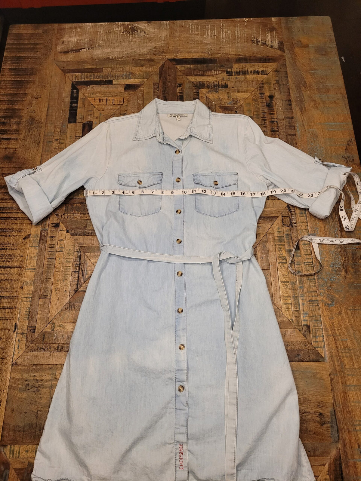 a denim shirt with a measuring tape on it.