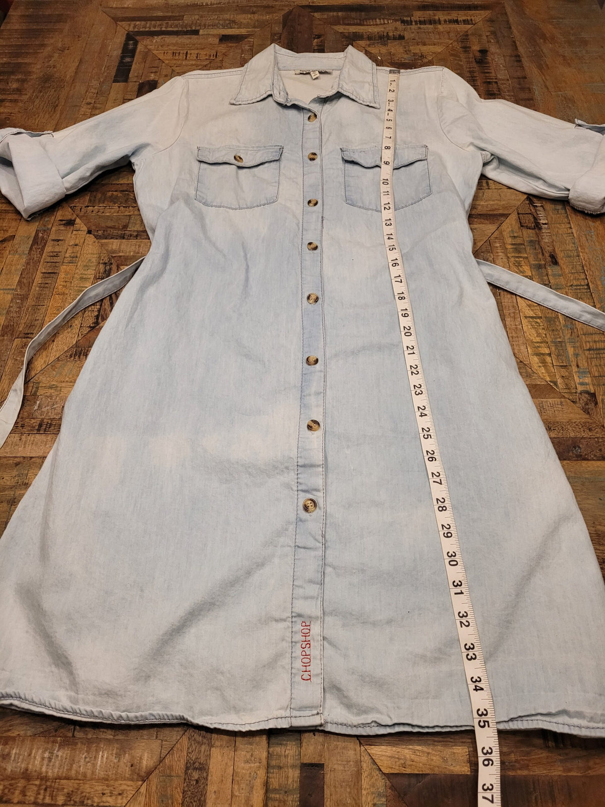 a denim shirt with a measuring tape around it.