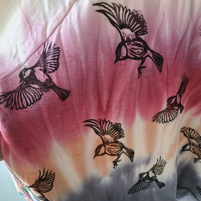 a tie dye shirt with birds on it.