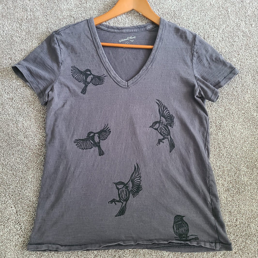 a gray v - neck t - shirt with birds on it.