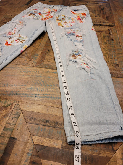 a pair of jeans with a measuring tape on the floor.