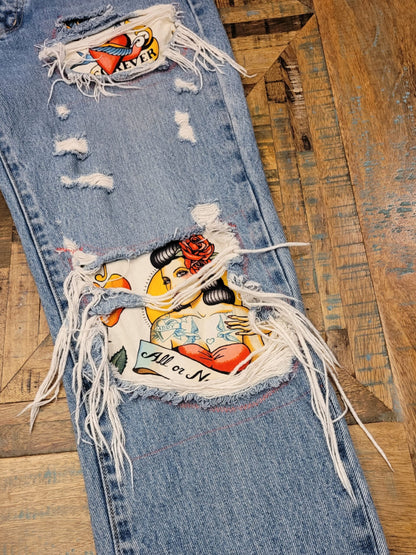 a pair of ripped jeans with patches on them.