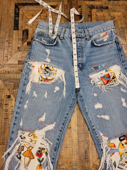 a pair of ripped jeans with a tape measure.