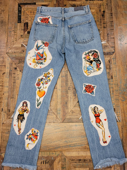 a pair of jeans with a lot of tattoos on them.