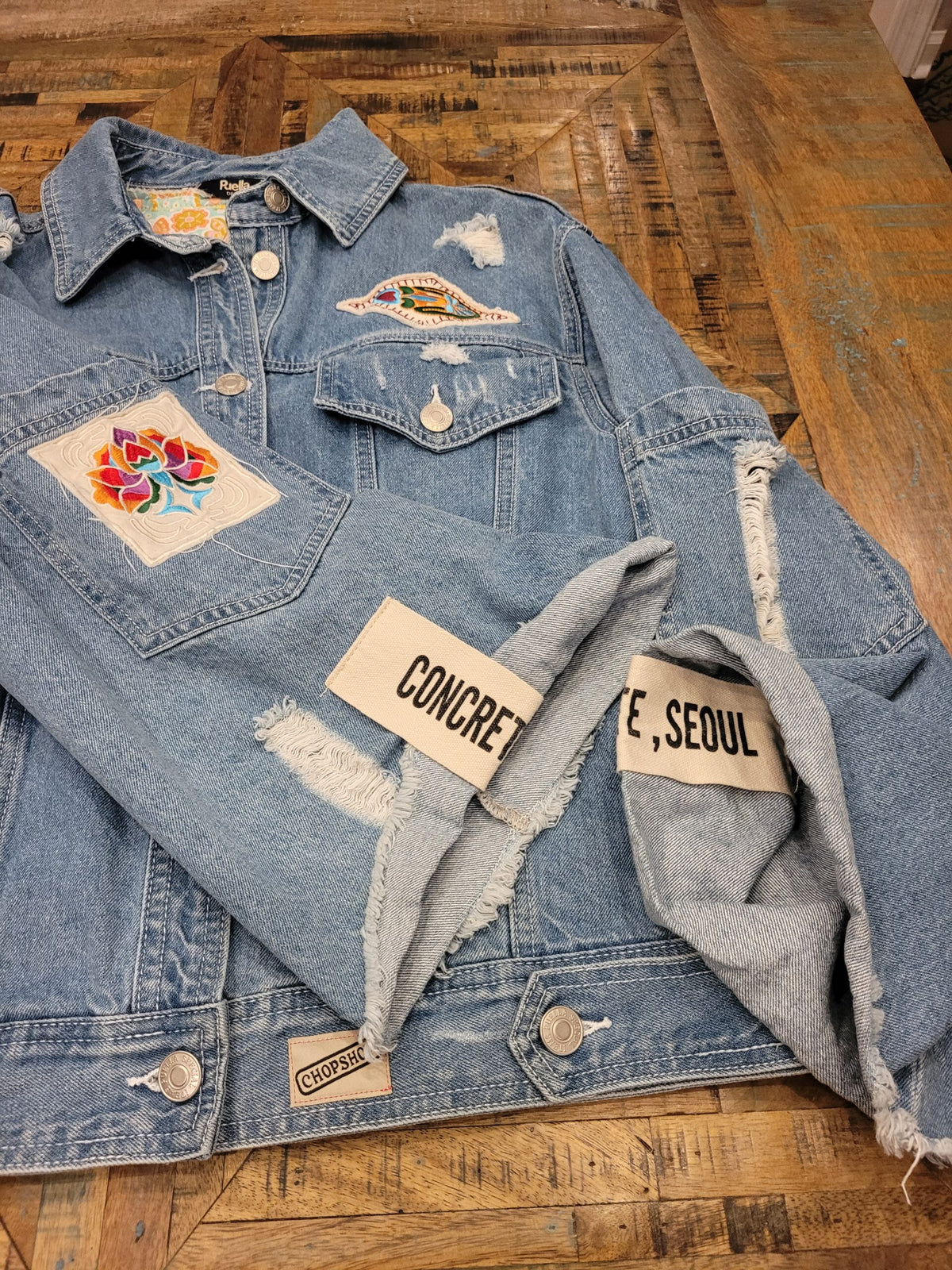 a denim jacket with patches on it.