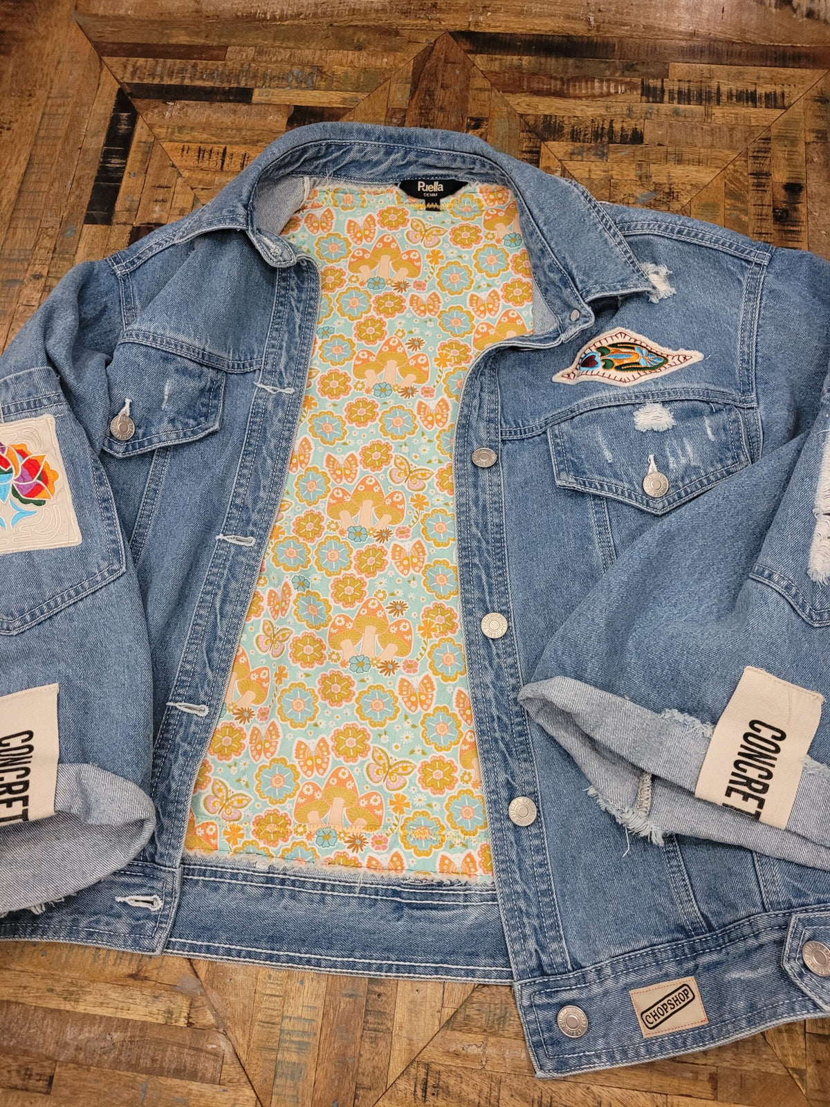 a denim jacket with patches on it.