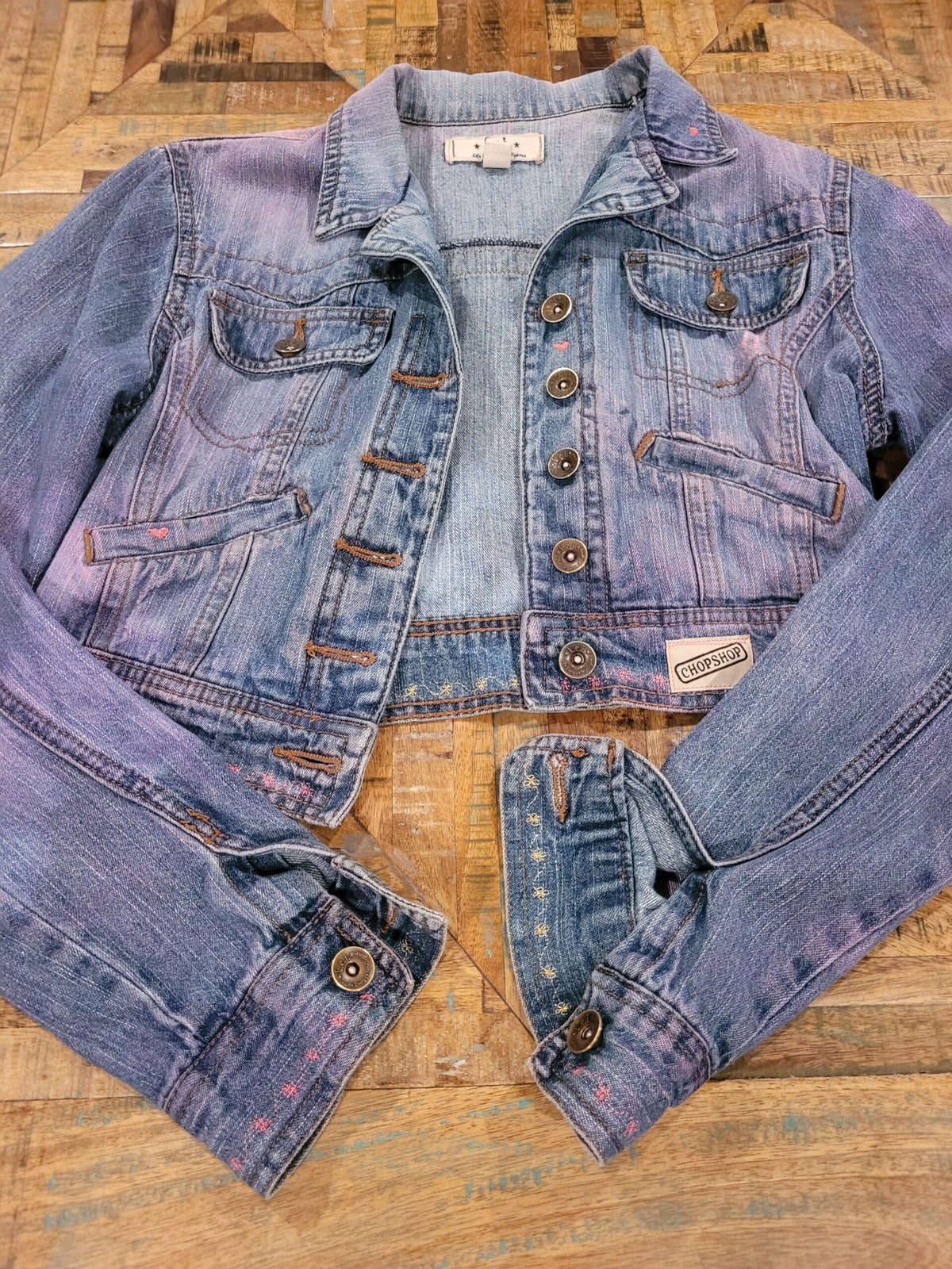 a denim jacket on a wooden table.