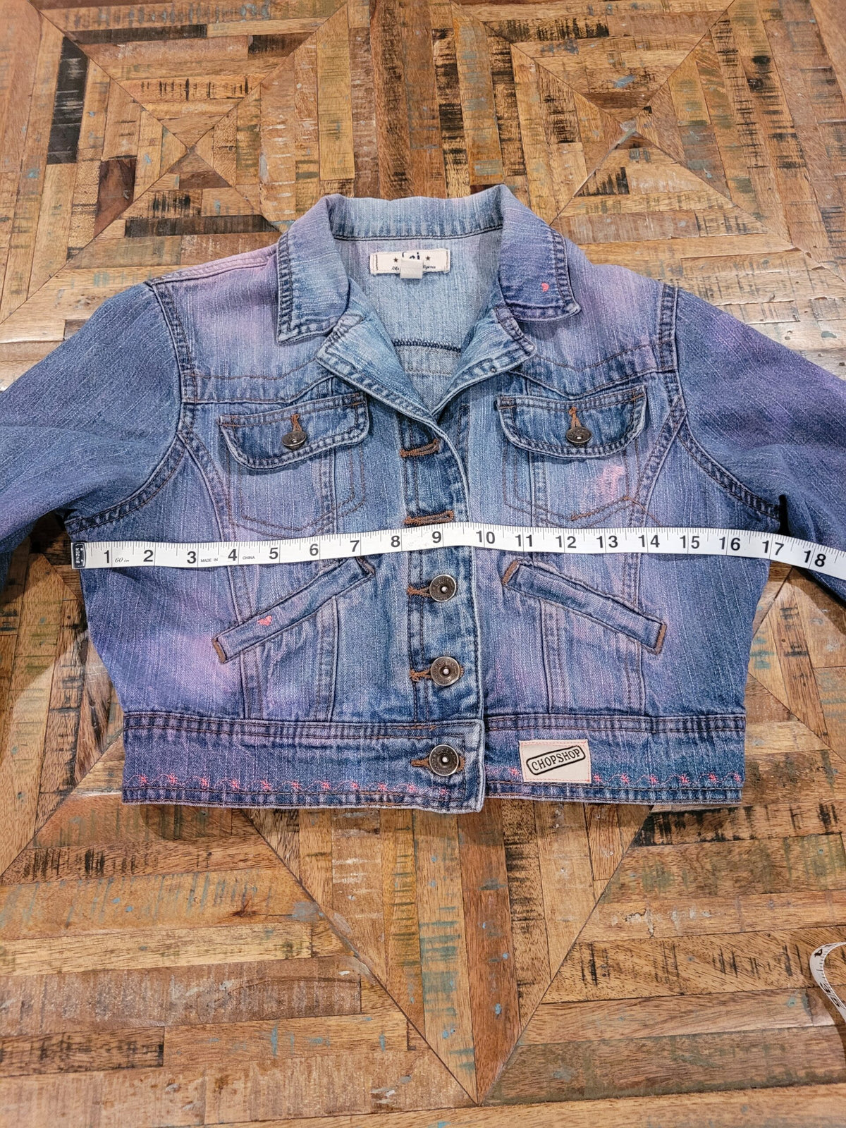 a denim jacket with a measuring tape on it.