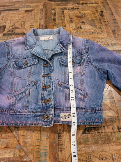 a denim jacket with a measuring tape on it.
